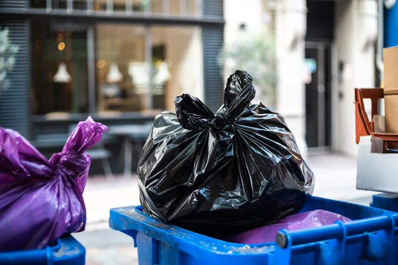 Household waste bags in outdoor bins